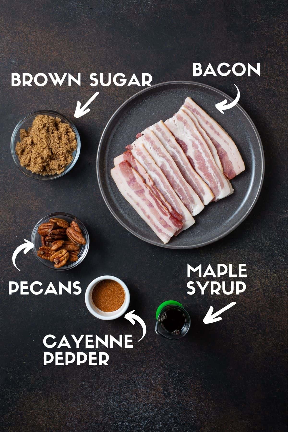 bacon, pecans, brown sugar, maple syrup and cayenne pepper on black board.