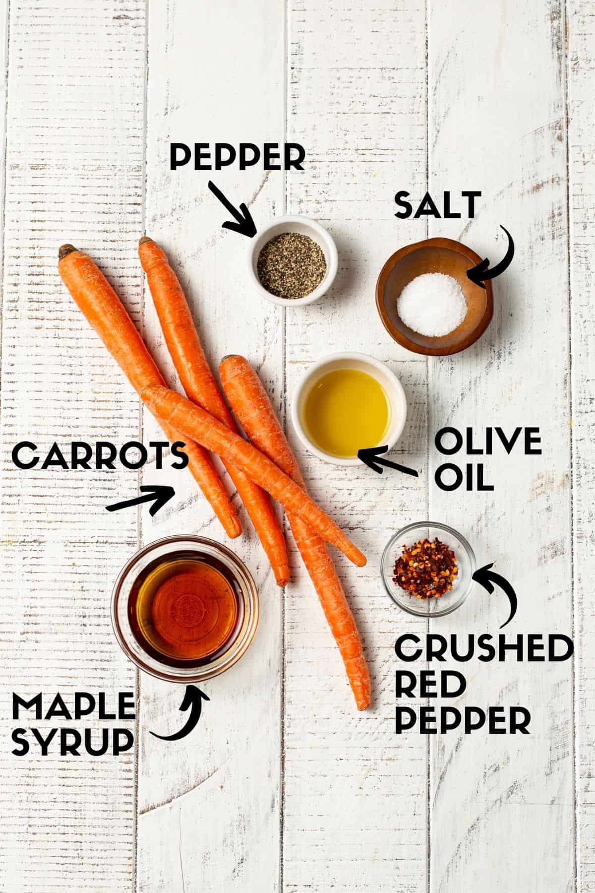 Ingredients needed for roasted carrots, including carrots, maple syrup and crushed red pepper. 