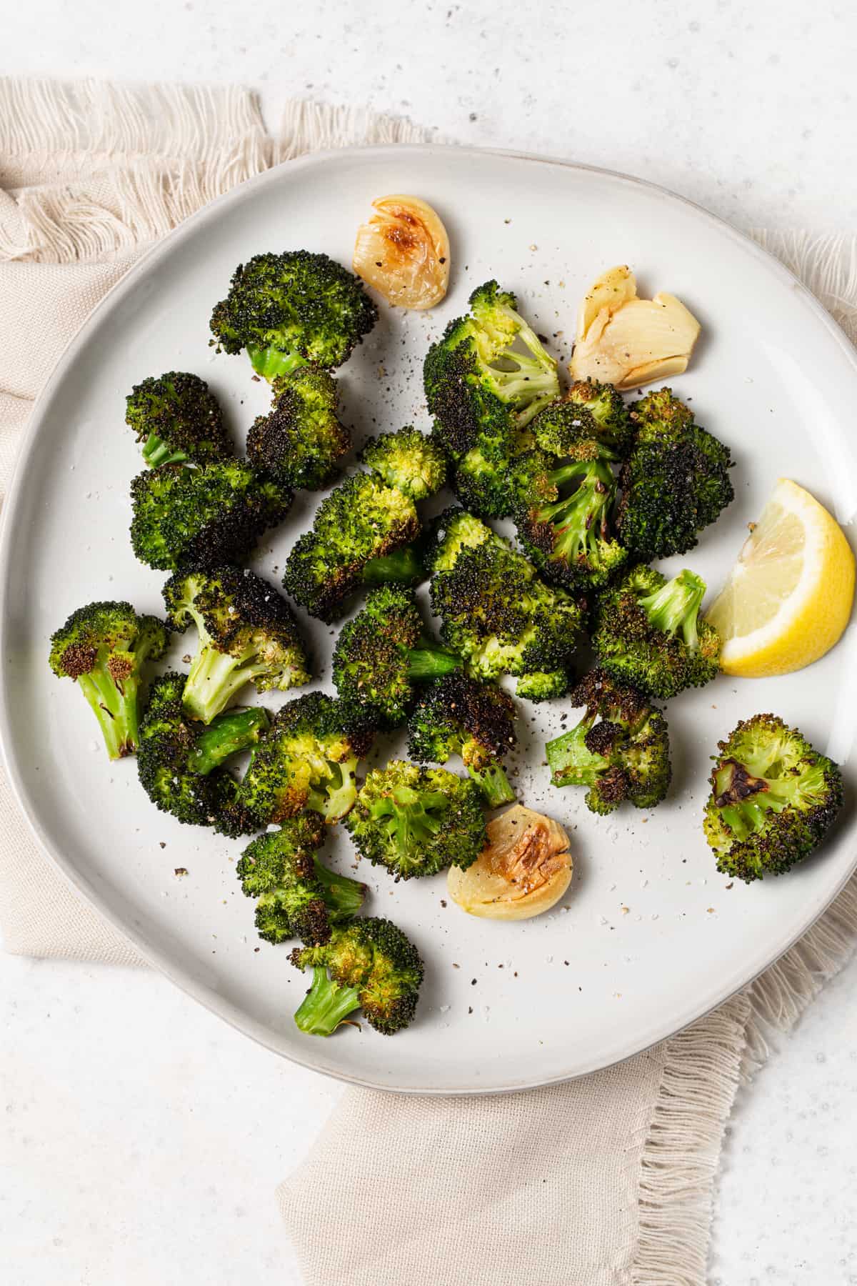 Roasted broccoli on a white plate. 