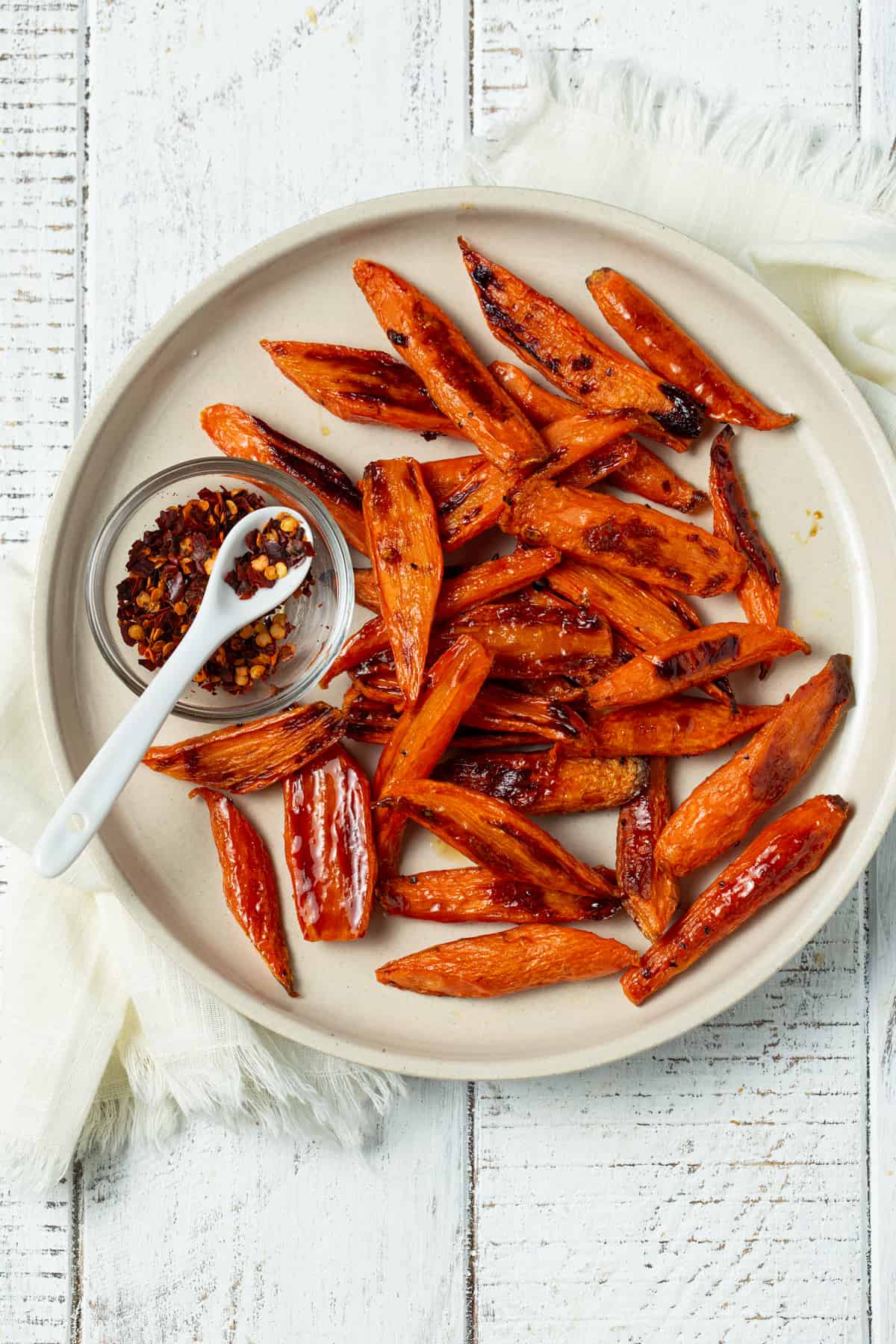 Roasted carrots on a white plate. 