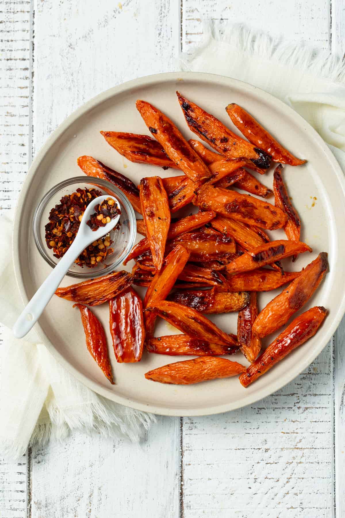 Roasted carrots on a white plate.