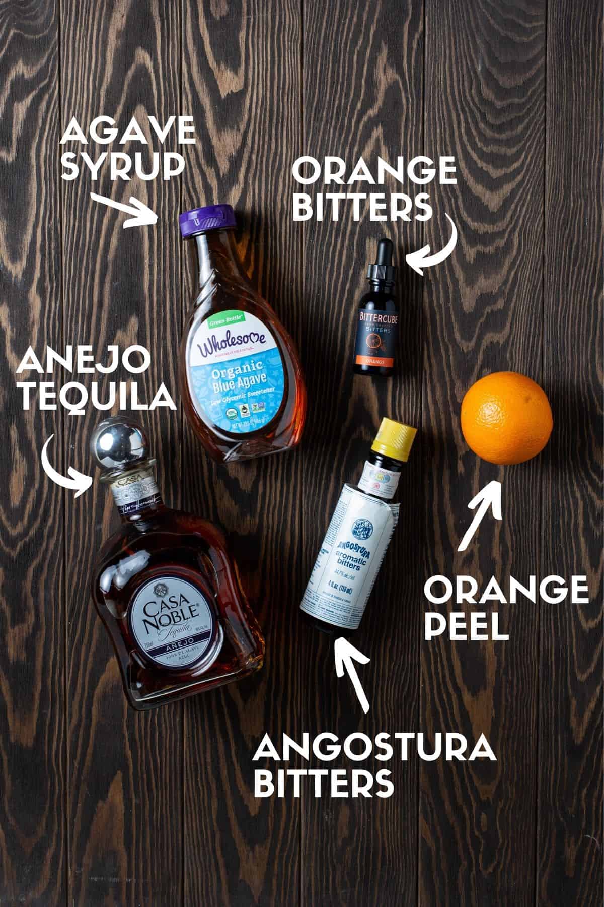 Ingredients for Tequila Old Fashioned drink including tequila, bitters and agave.