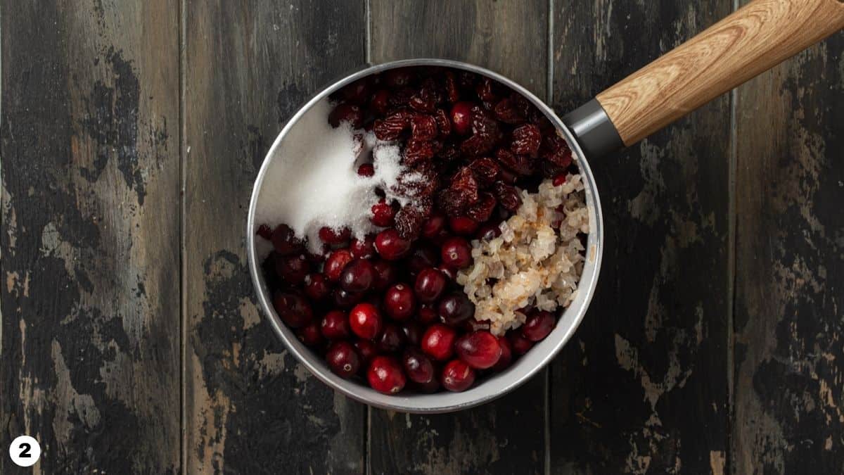 Ingredients for cranberry sauce in a pot. 