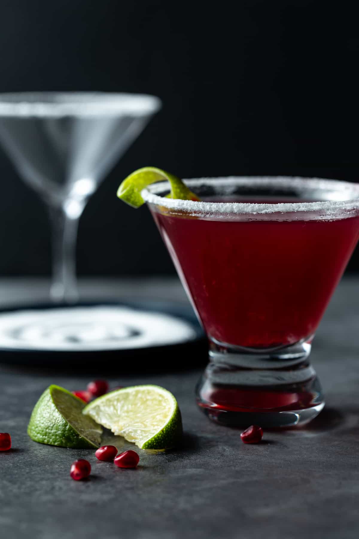 A glass filled with pomegranate martini. 