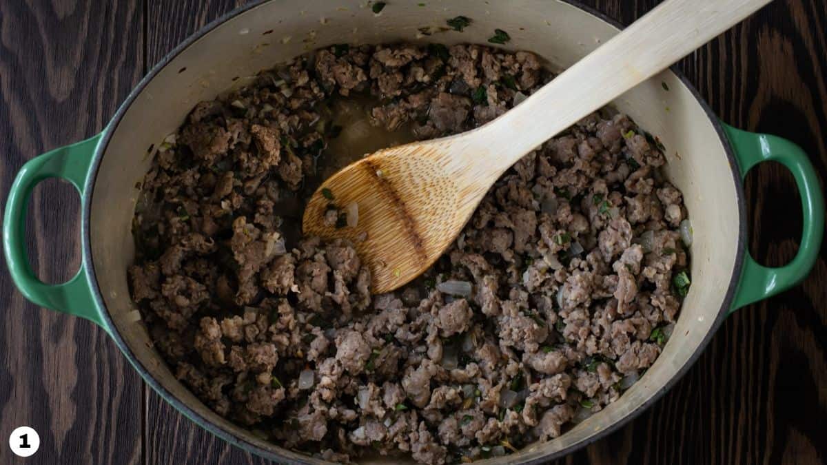 Italian sausage, garlic and onions browned in a dutch oven.