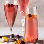 champagne flutes filled with cranberry juice and prosecco.