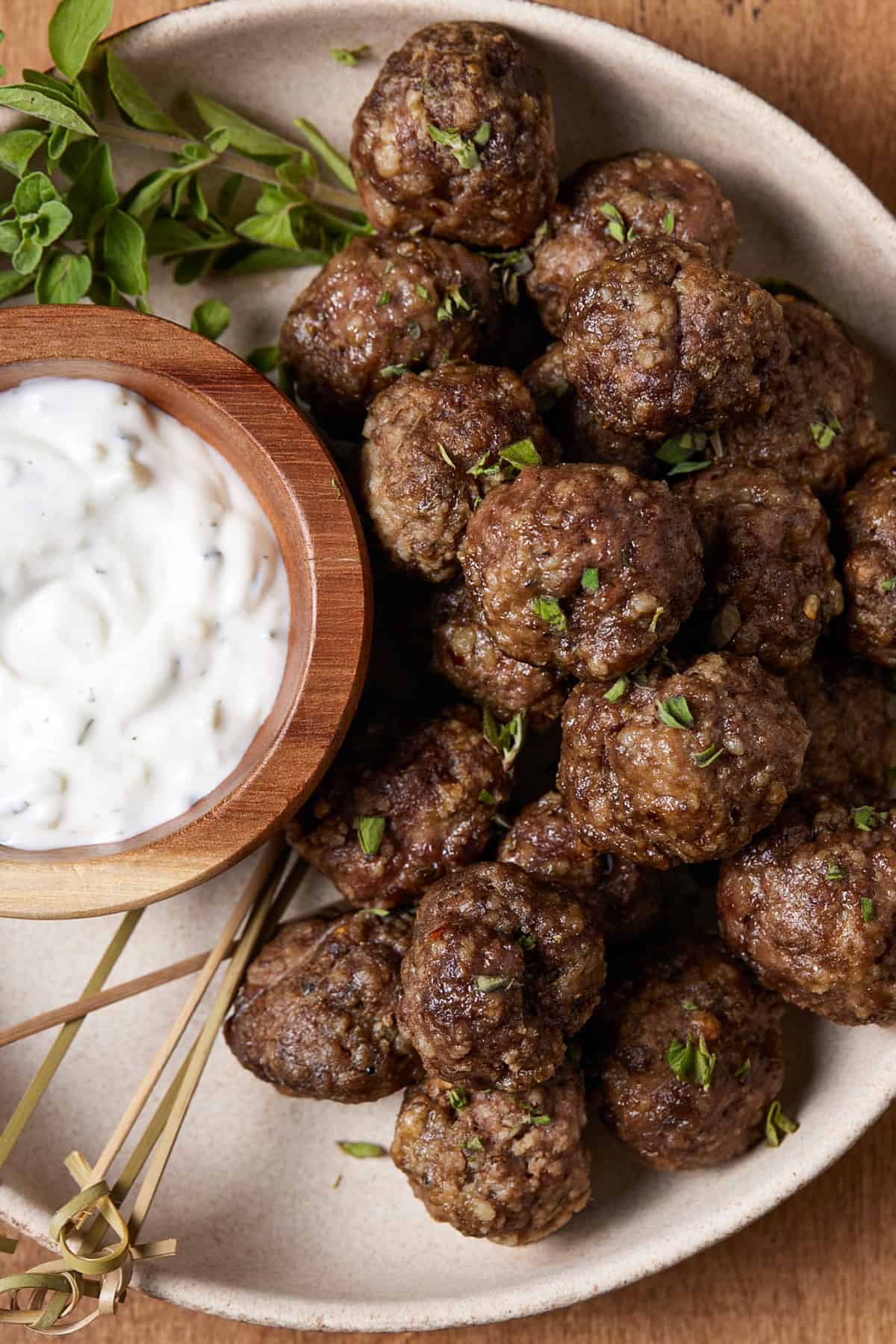 meatballs on a plate with dipping sauce.