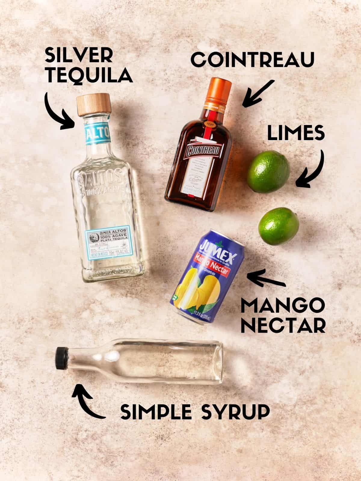 Ingredients to make mango margaritas, including tequila, orange liqueur and mango nectar. 