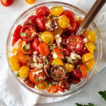 chopped tomatoes in bowl with cheese.