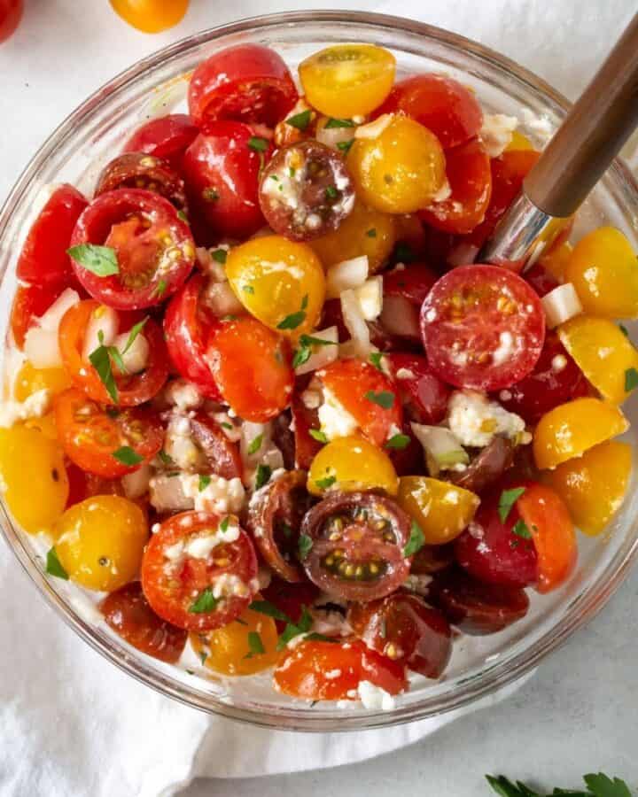 chopped tomatoes in bowl with cheese.
