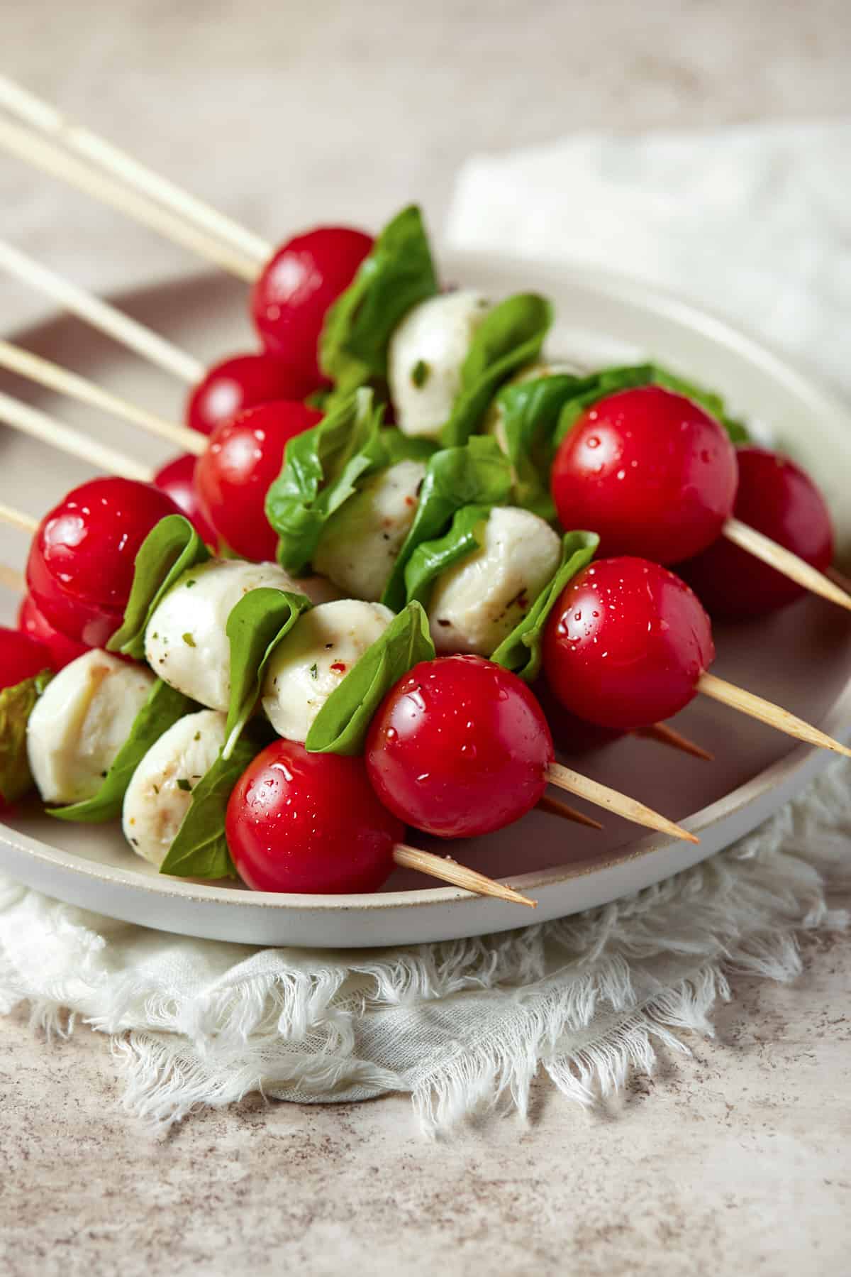 Caprese skewers on a light plate. 