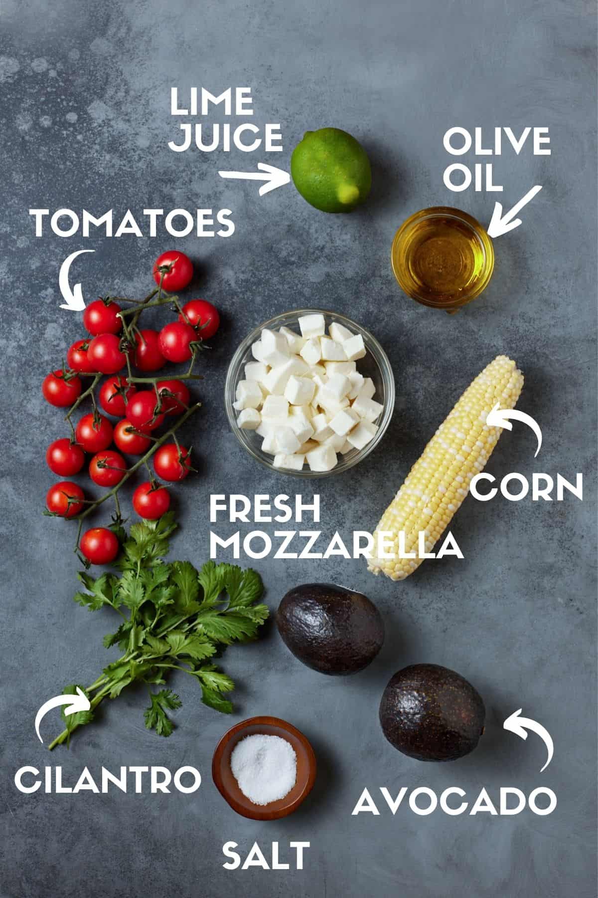 Ingredients for Corn Avocado Salad, including tomatoes, fresh mozzarella and cilantro. 