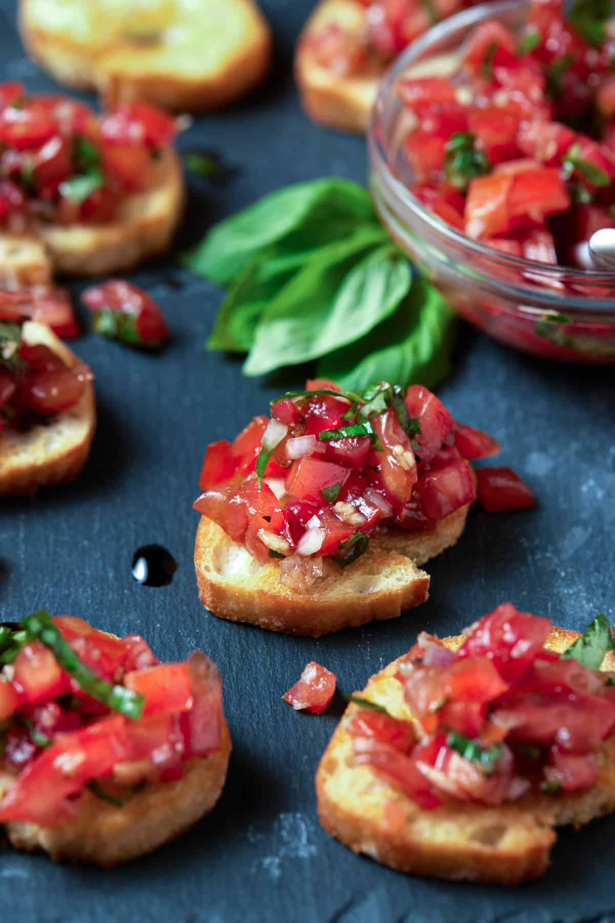 Tray of tomato bruschetta with fresh basil.