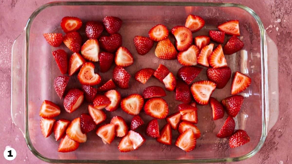 Chopped strawberries in a glass baking dish. 