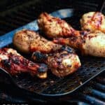 grilled chicken legs on grill.