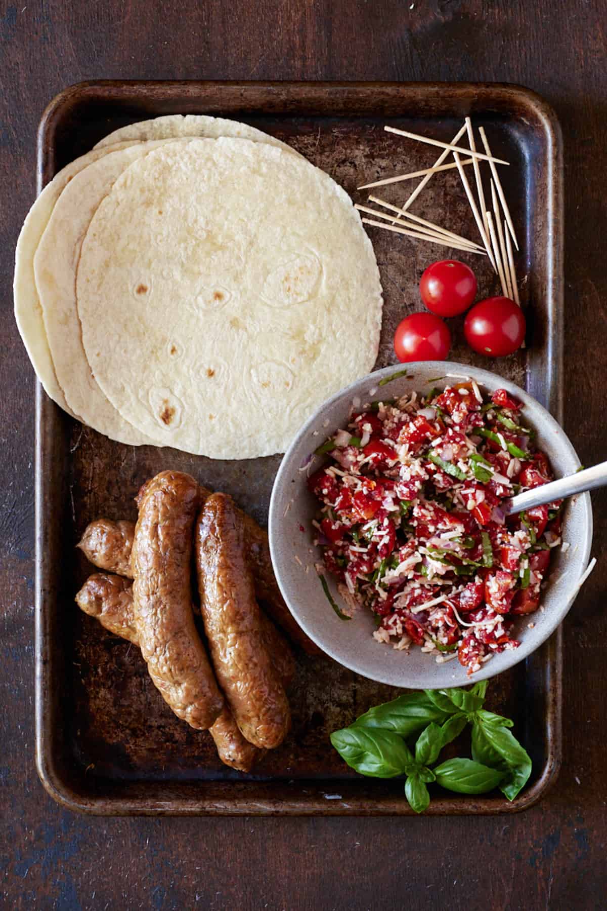 Sheet pan with Italian Sausage, tortillas and tomato bruschetta topping. 