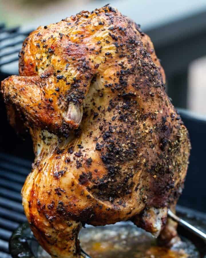 Whole seasoned chicken on the grill.