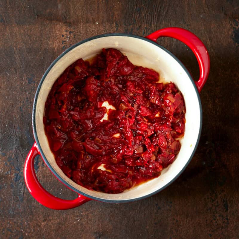 Tomato jam in a red dutch oven.