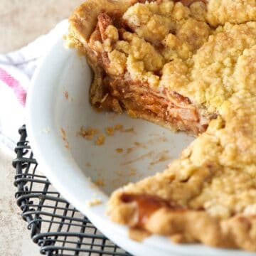 apple crumble pie in white baking dish.