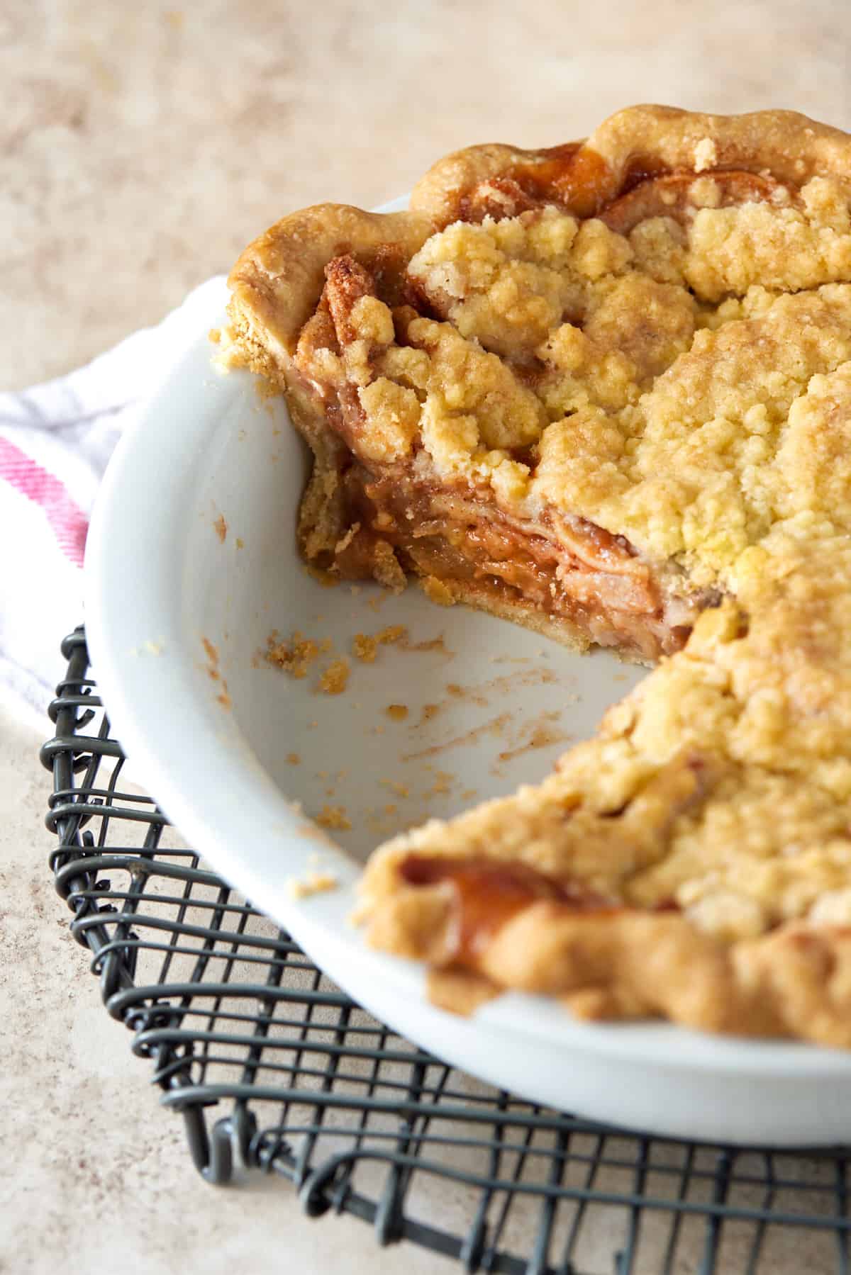 Apple pie in white baking dish.