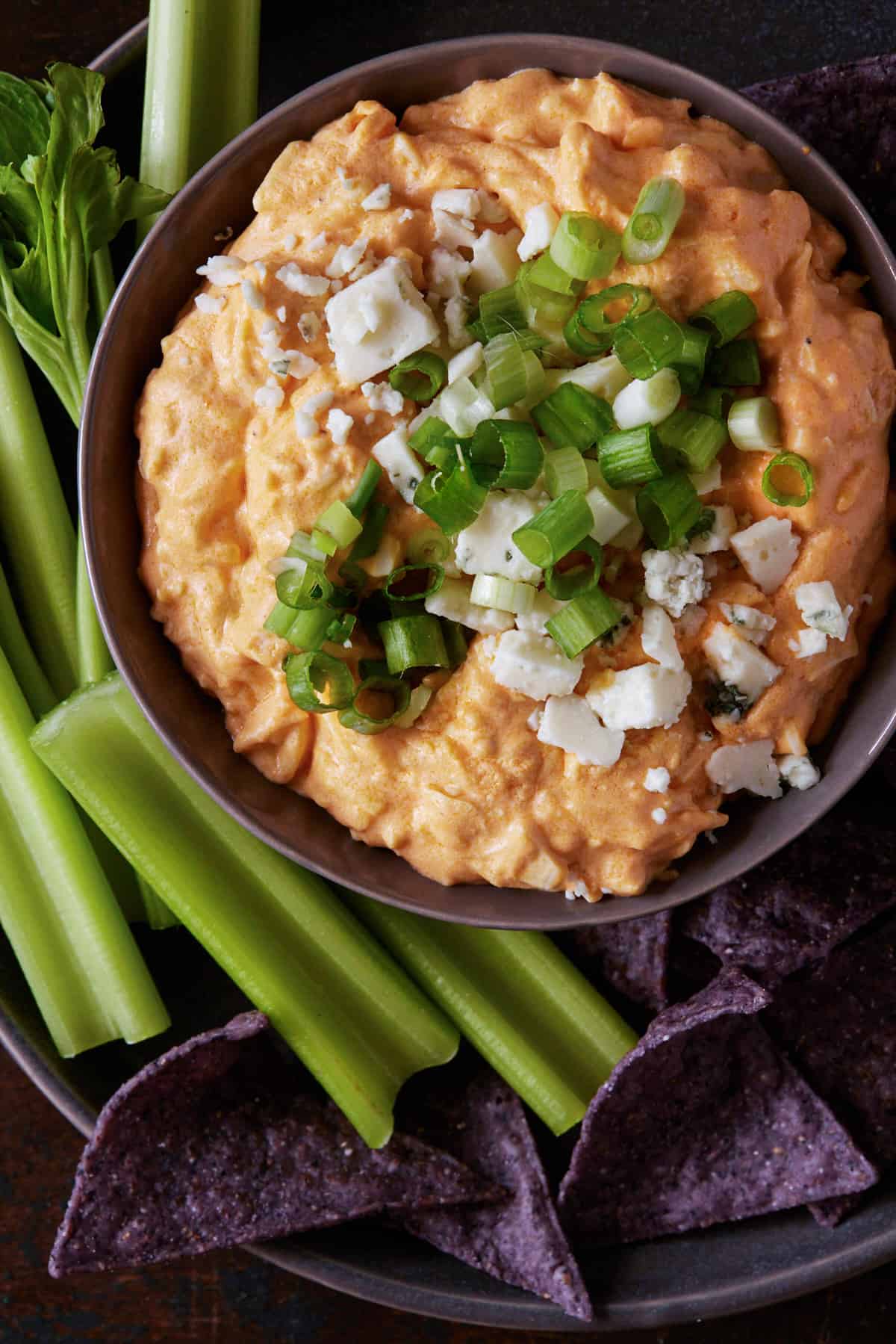 Buffalo chicken dip in a bowl with celery.