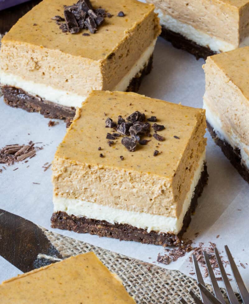 Pumpkin Cheesecake Bars on parchment paper.