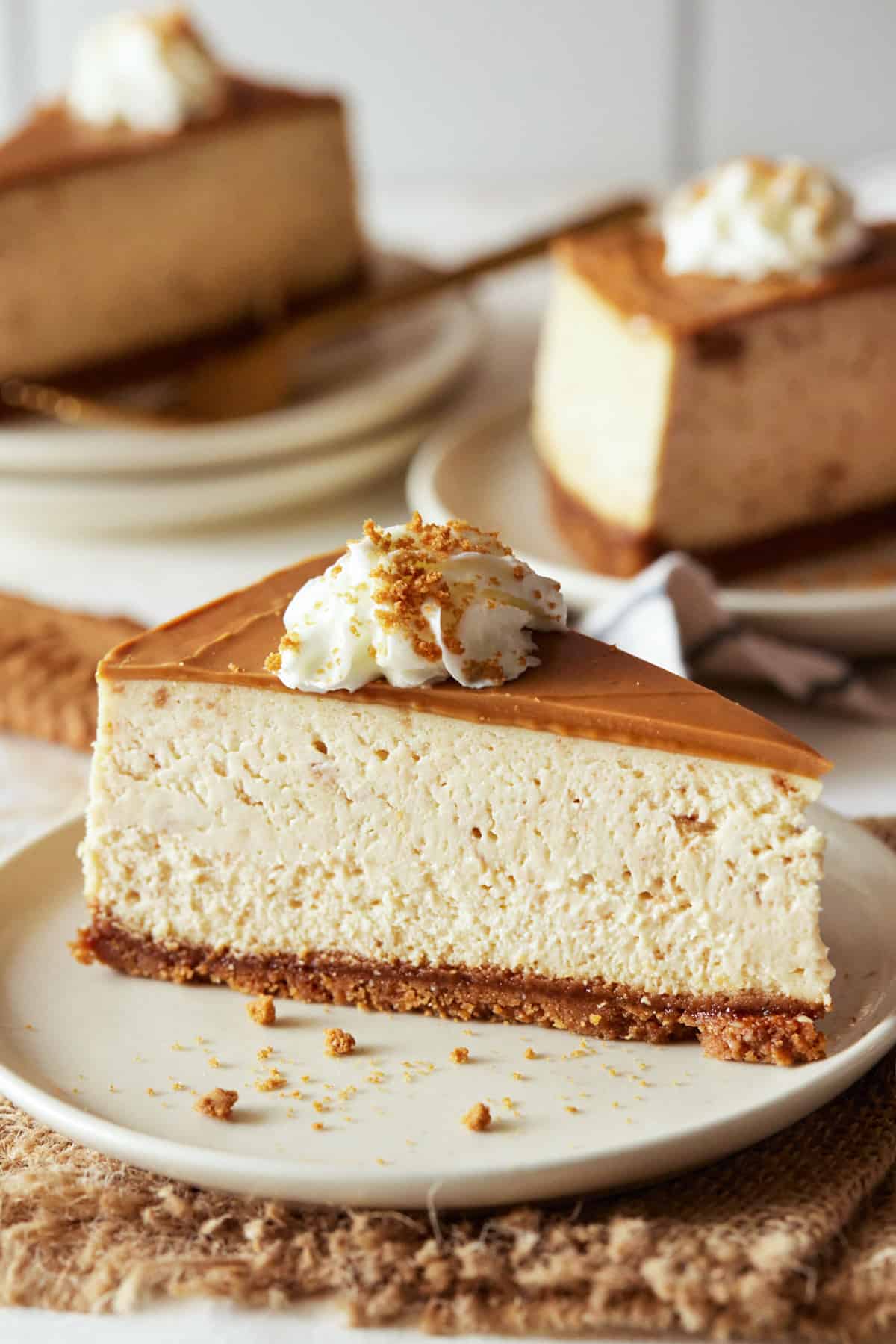 Pieces of Biscoff. cheesecake on cream plates. 