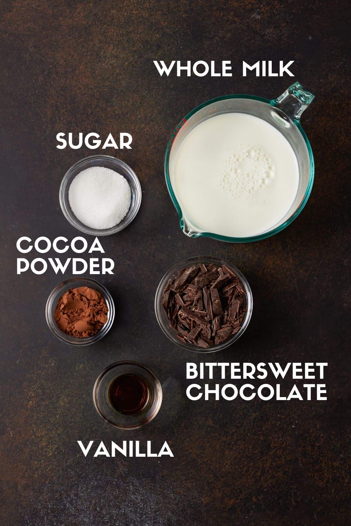 Bowls of chocolate, cocoa, milk, sugar and vanilla to make spiked hot chocolate. 