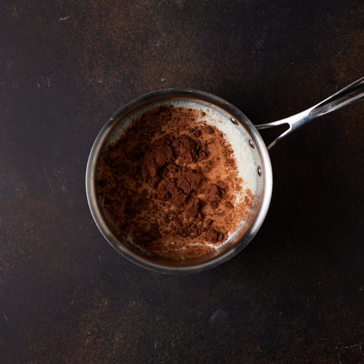 Milk, cocoa powder and sugar in a saucepan.