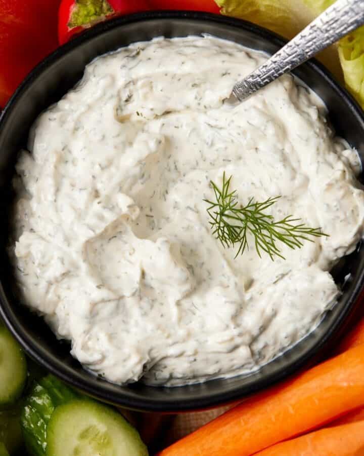 Dill dip in a bowl with fresh veggies.