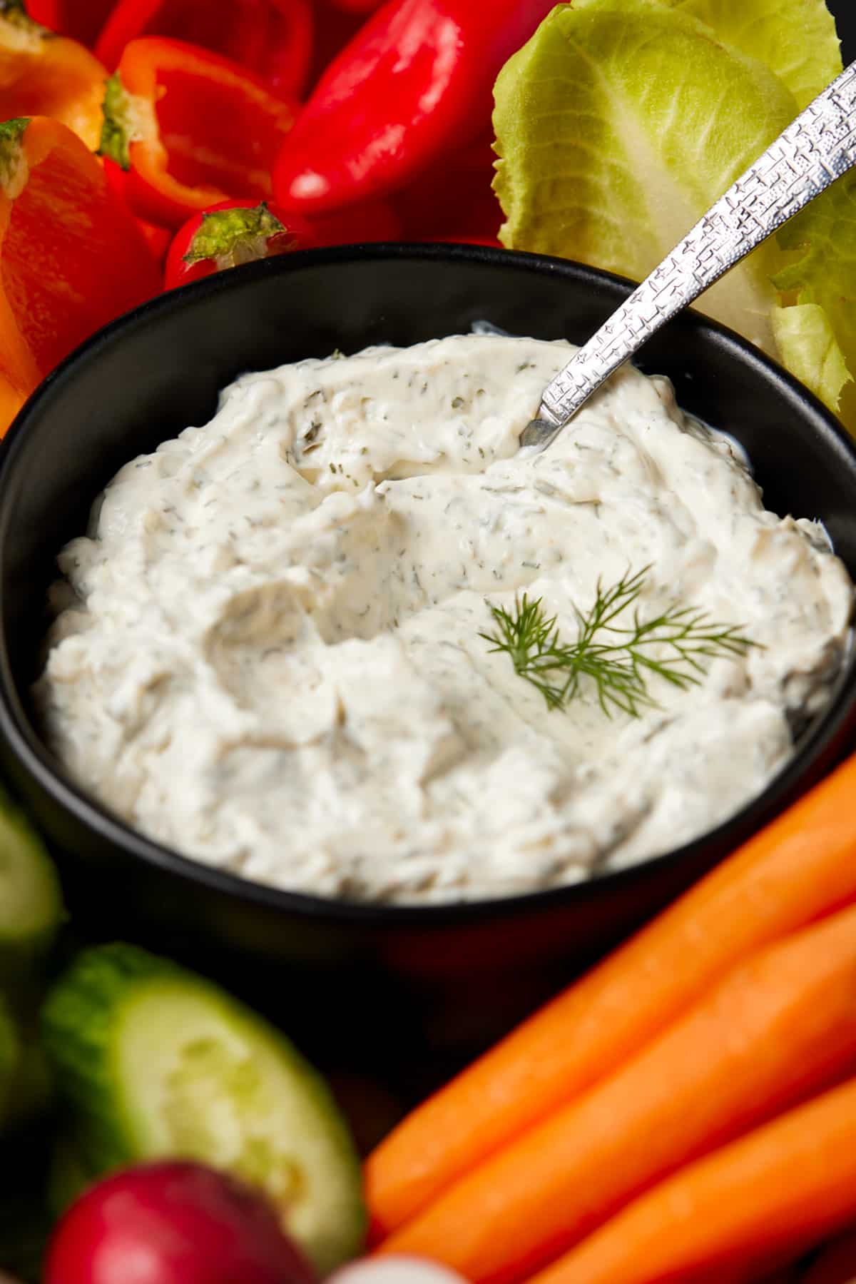 Dill dip in bowl with fresh veggies for dipping.,