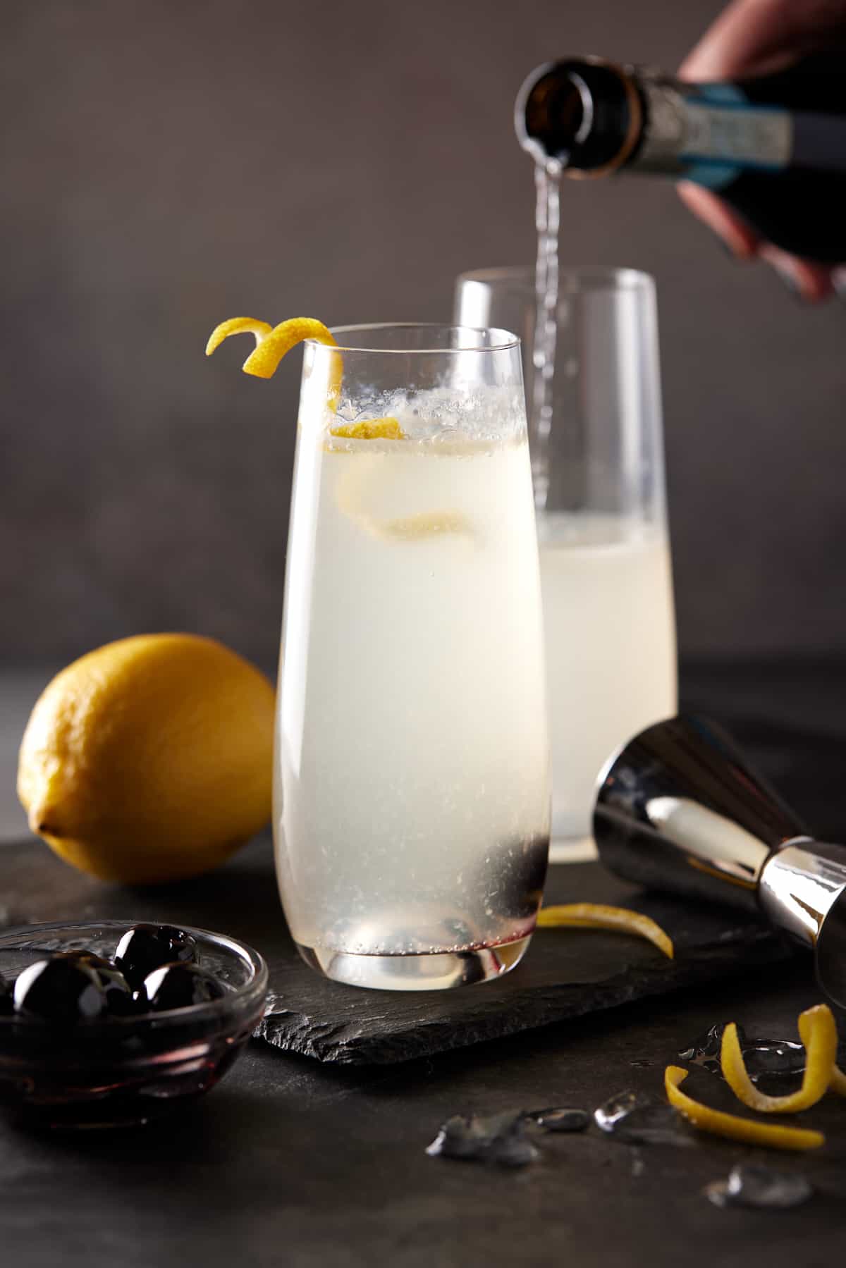 Filled champagne flute with bottle pouring prosecco into glass.