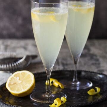 filled champagne flutes with lemon twists for garnish.
