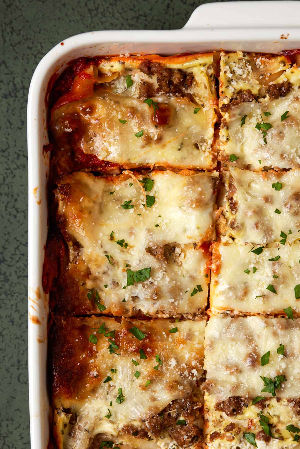 Baked lasagna in white dish.