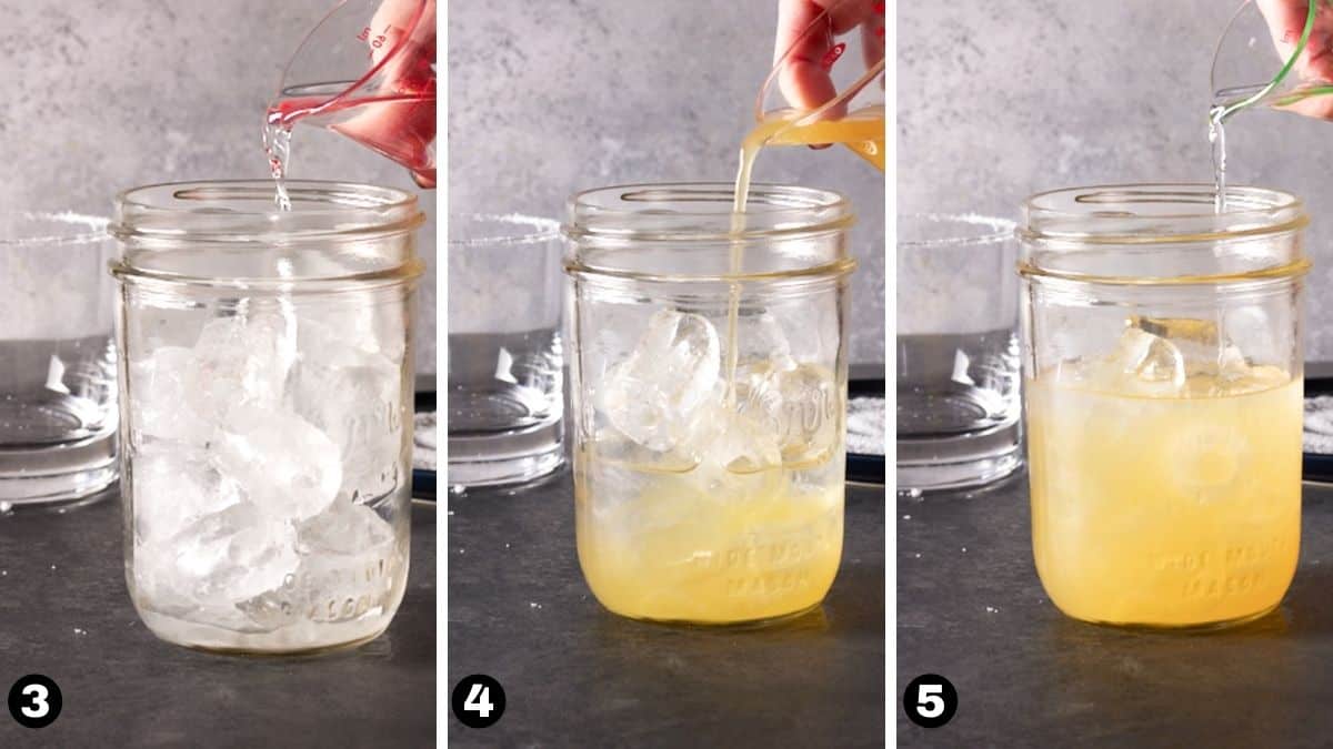 Hand pouring liquor into mason jar filled with ice.