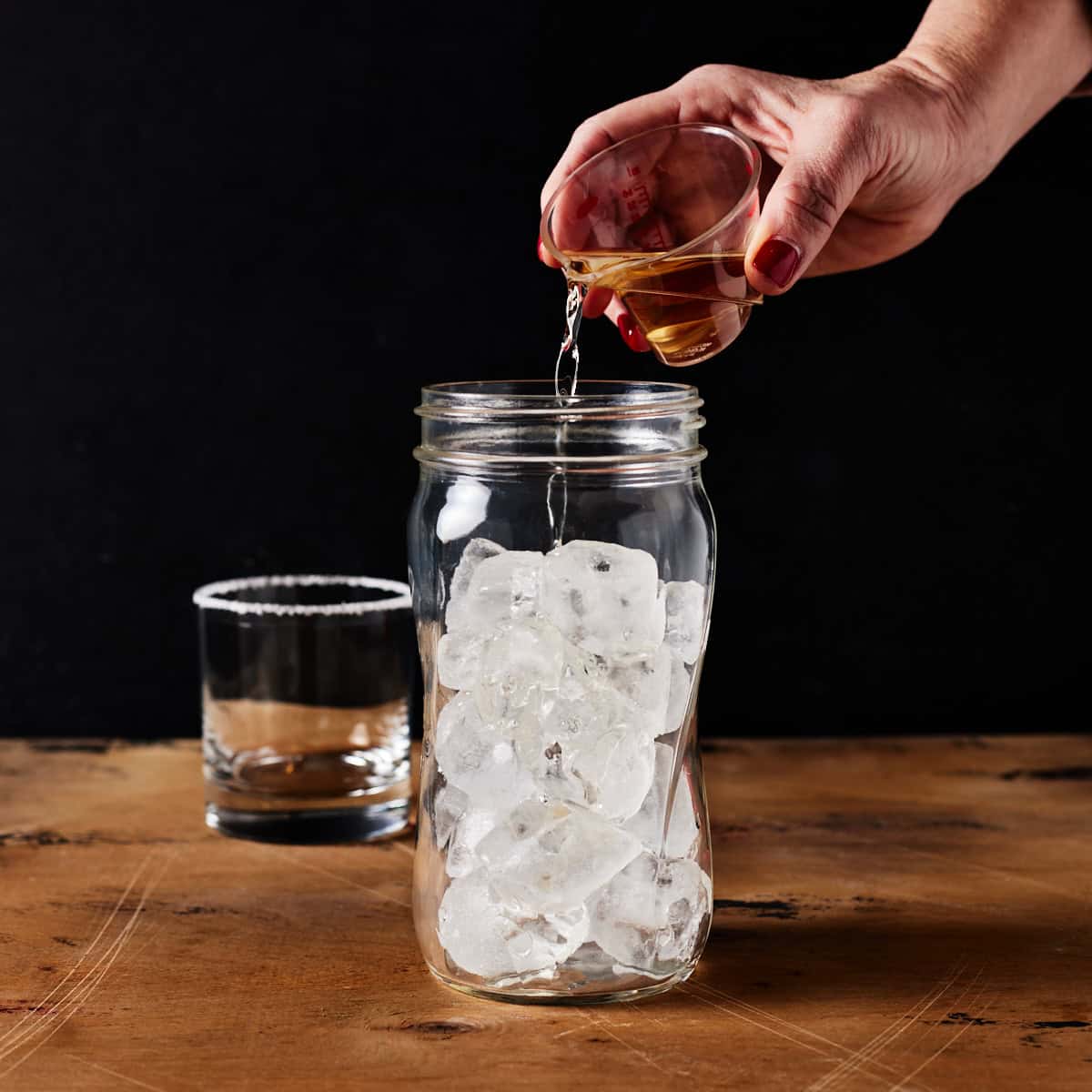 ice filled shaker with salt rimmed glass.