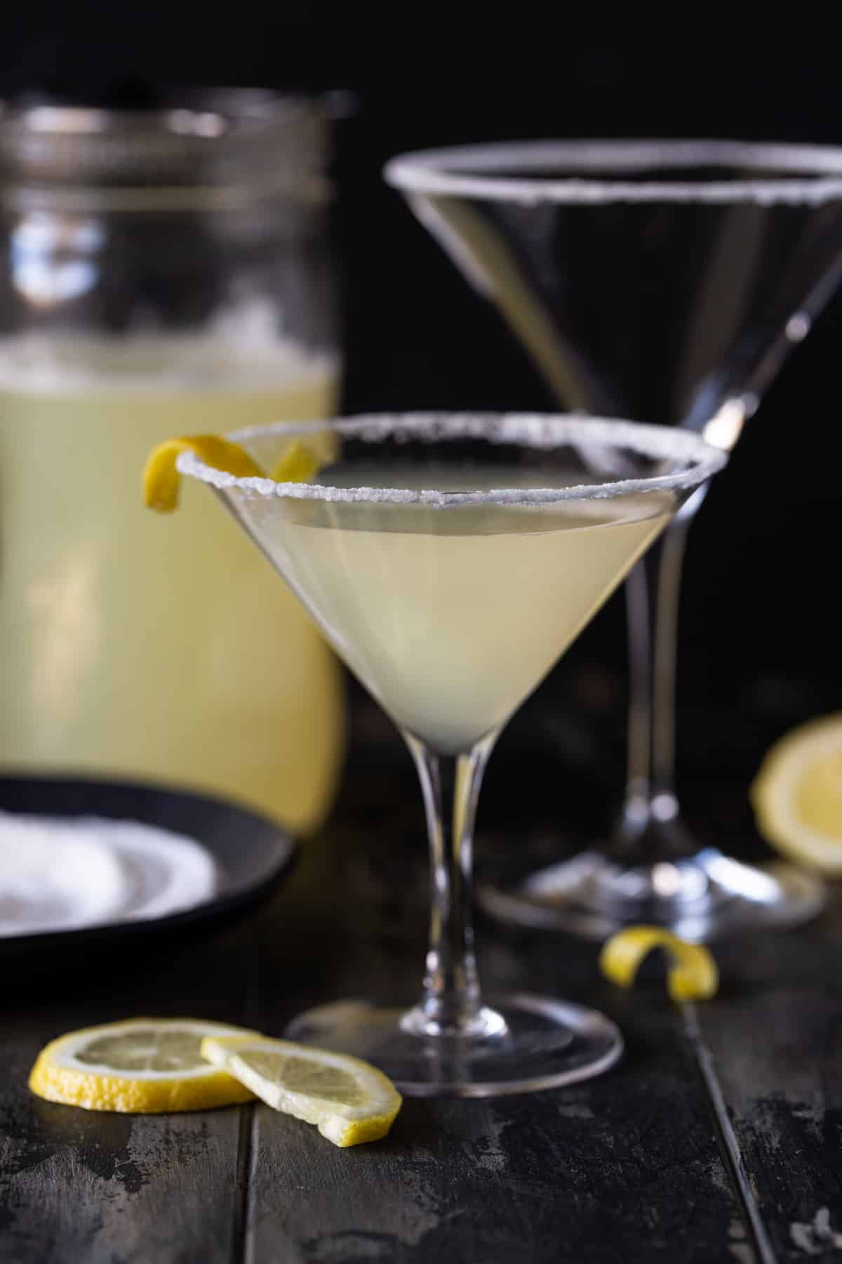 Lemon drop martinis in glasses with lemon twists for garnish.