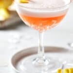 Aperol Sour with lemon twist in coupe glass.