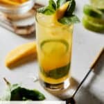 Mojito in highball with mango and mint.