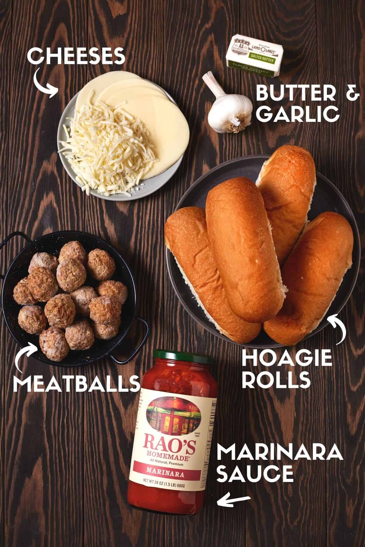 Ingredients for meatball subs including marinara sauce, meatballs, hoagie buns & cheese. 