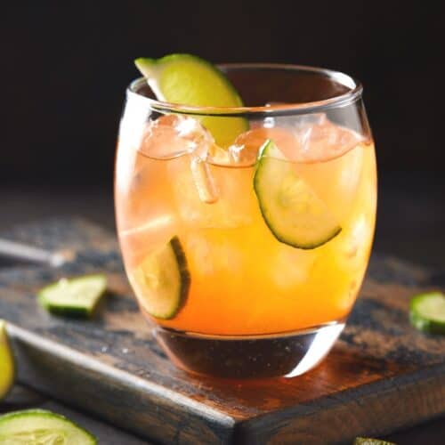 Single aperol gin cocktail in low ball glass.