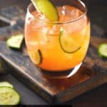 Aperol drink with cucumber slices.