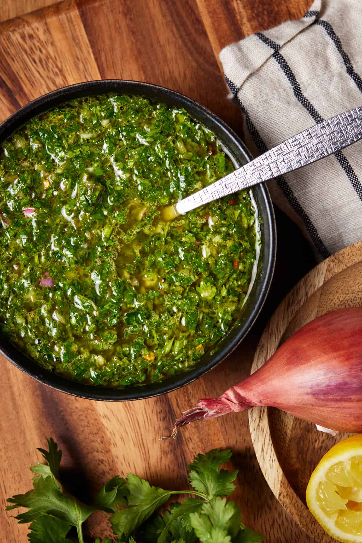 Black bowl of chimichurri sauce. 