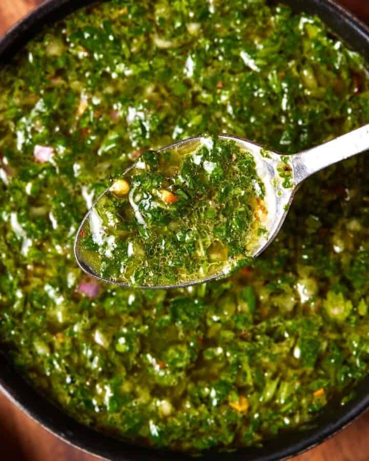chimichurri in small bowl with spoon.