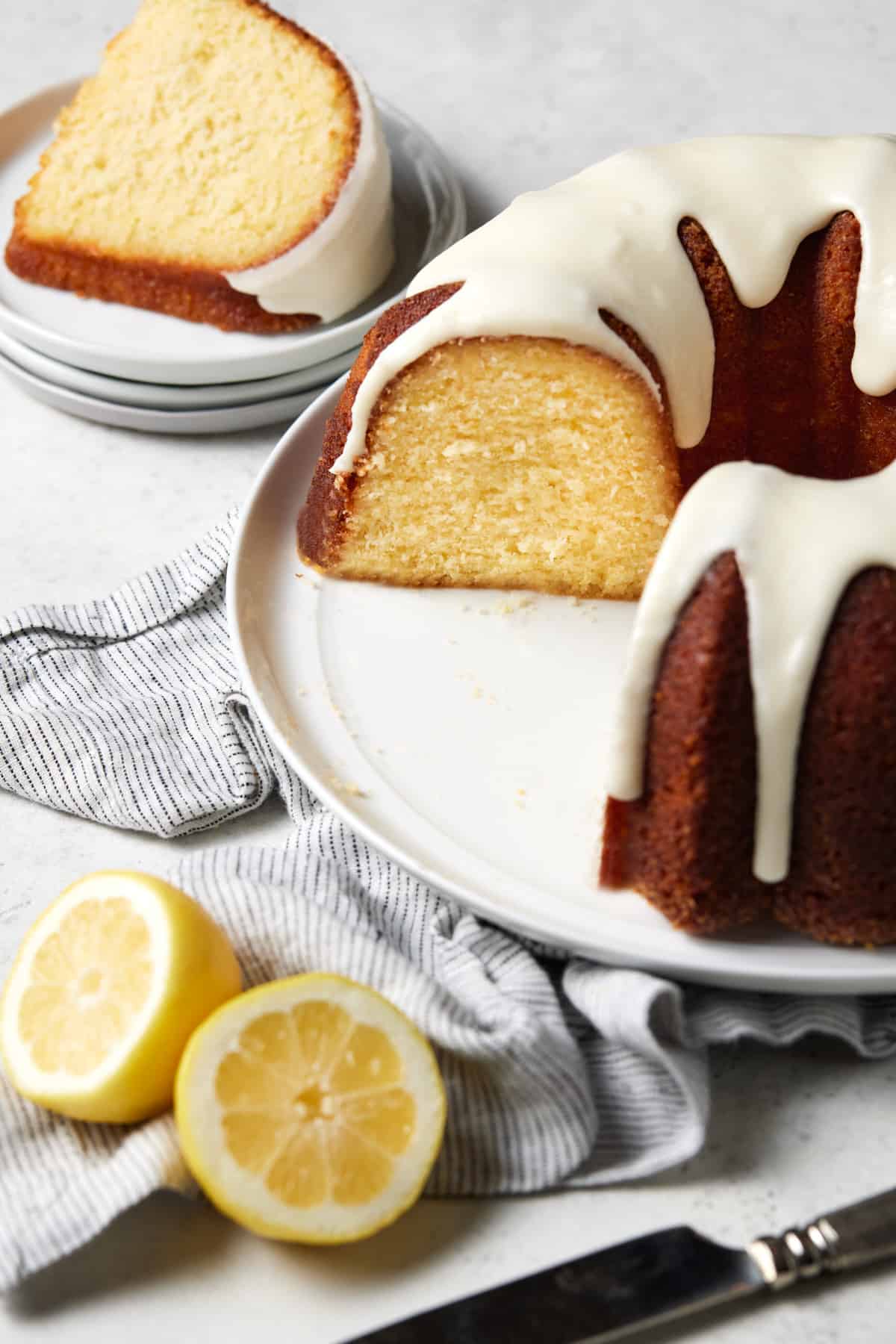 Sliced lemonade bundt cake on a white plate. 