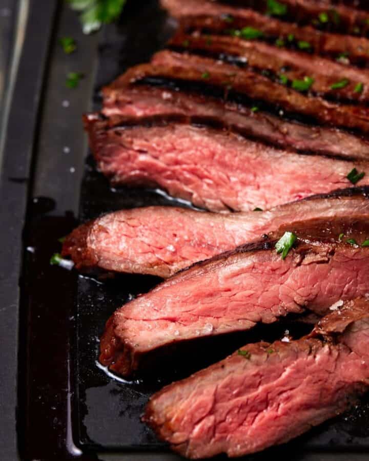 sliced steak on tray.