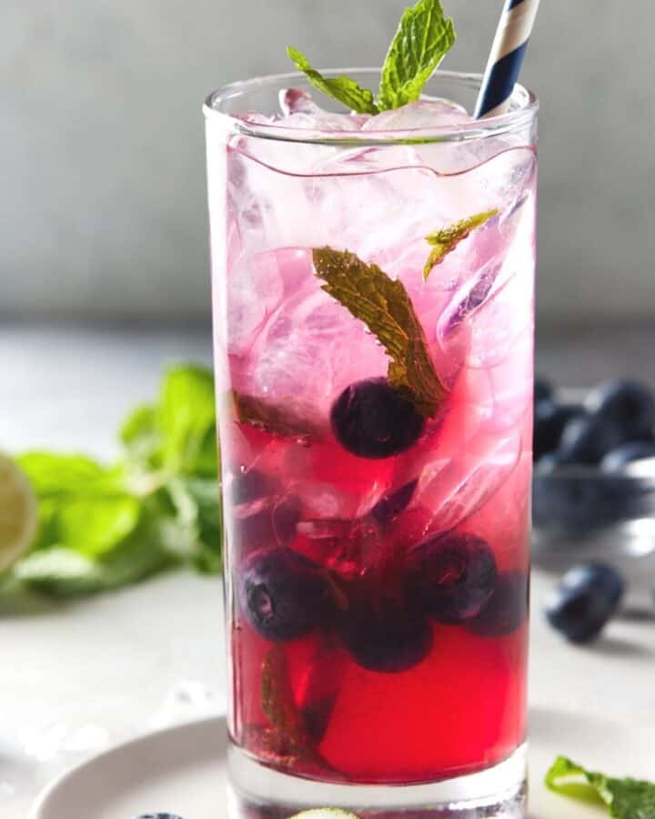 blueberry mojito in glass with fresh mint.