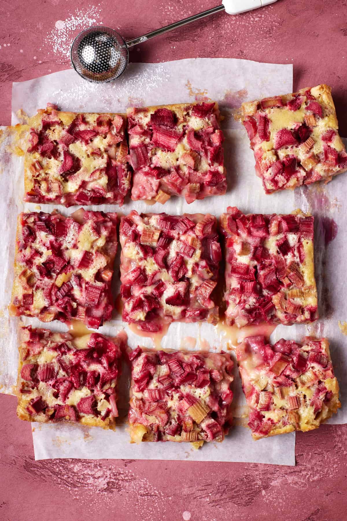 Rhubarb bars with powdered sugar duster.