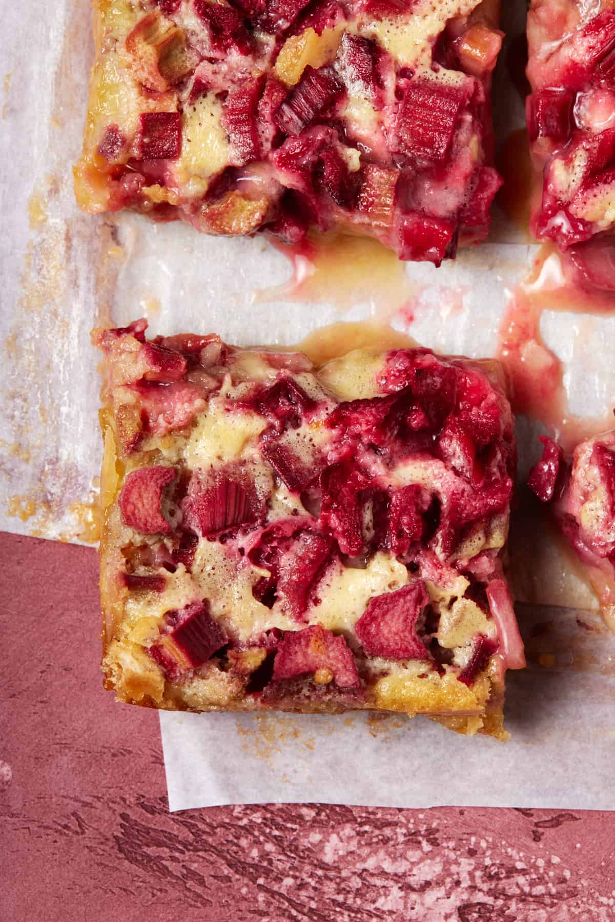 Rhubarb squares on parchment paper.