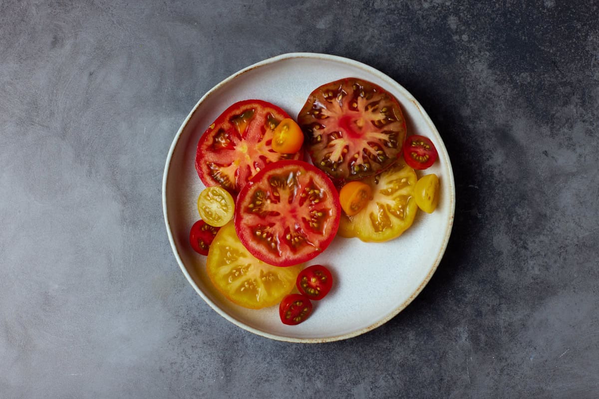 Sliced heirloom tomatoes in a shallow bowl. 